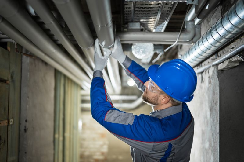 Plumber Working on a Pipe